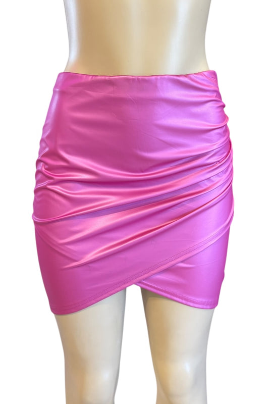 Pink shiny skirt on a mannequin against a white background