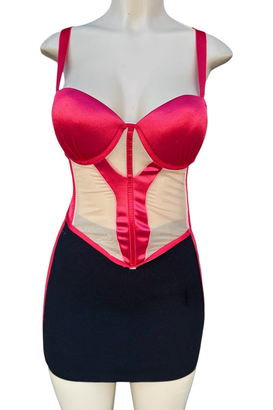 Mannequin wearing a red top and black skirt with mesh panels on a white background