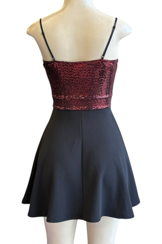 Black dress with red sequined top on a mannequin against a white background