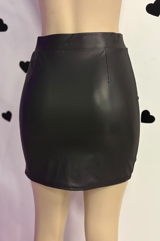Black leather skirt on a mannequin against a light background