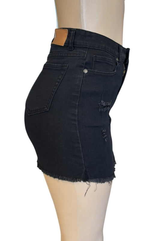 Black denim skirt on a mannequin with a white background
