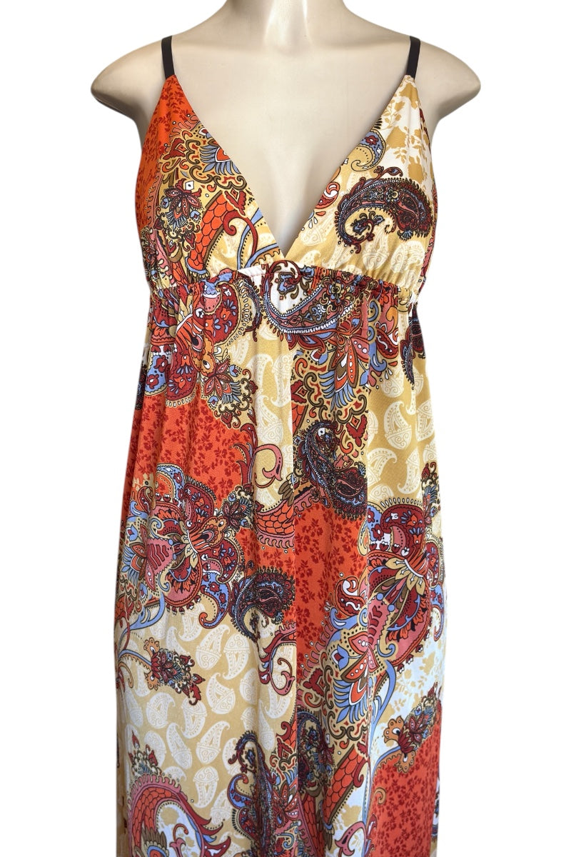 Colorful patterned dress on a mannequin against a white background