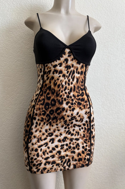 Leopard print dress with black top on a mannequin against a white background