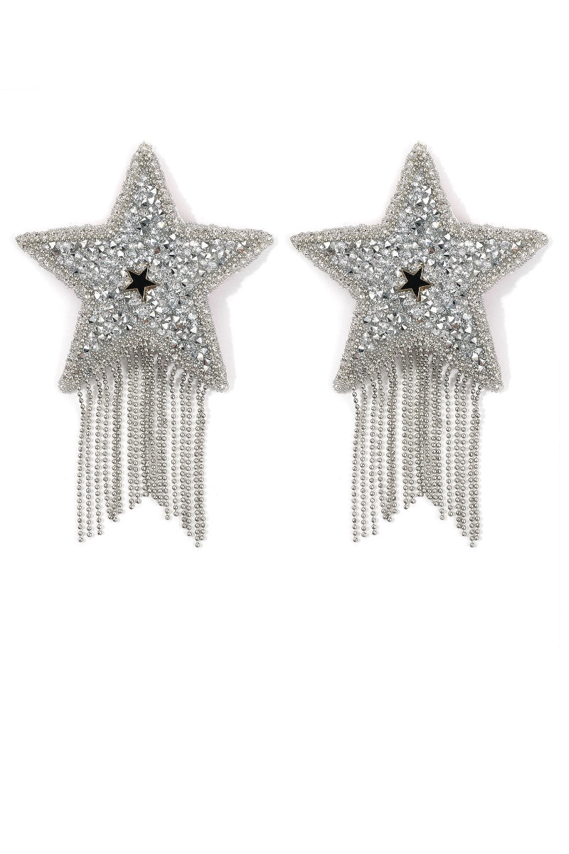 Star-shaped pasties with fringe details on a white background