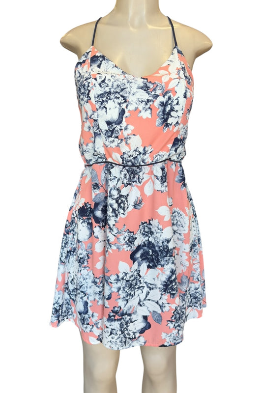 Floral dress with pink and blue pattern on a mannequin against a white background
