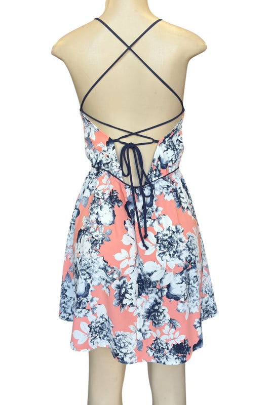 Floral dress with criss-cross back on a mannequin against a white background