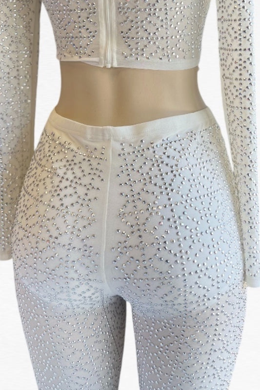 White outfit with long sleeves and rhinestone embellishments on a mannequin.