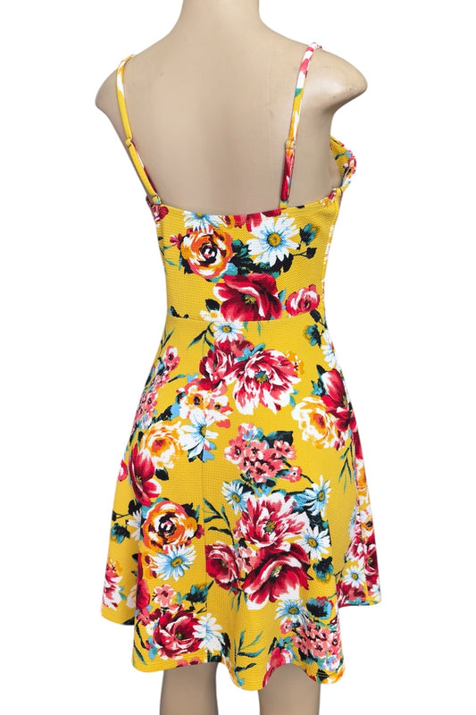Yellow floral dress on a mannequin with a white background