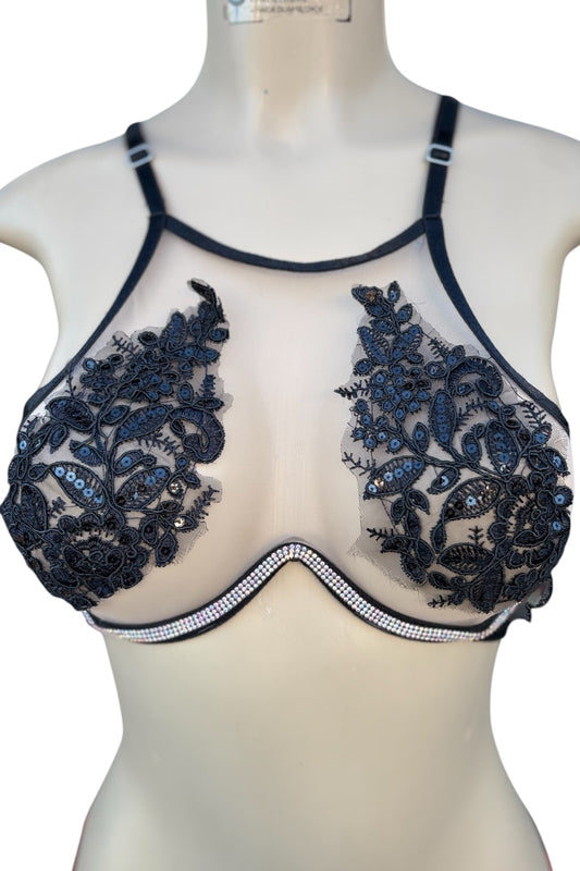 Black lace bra top on a mannequin against a white background