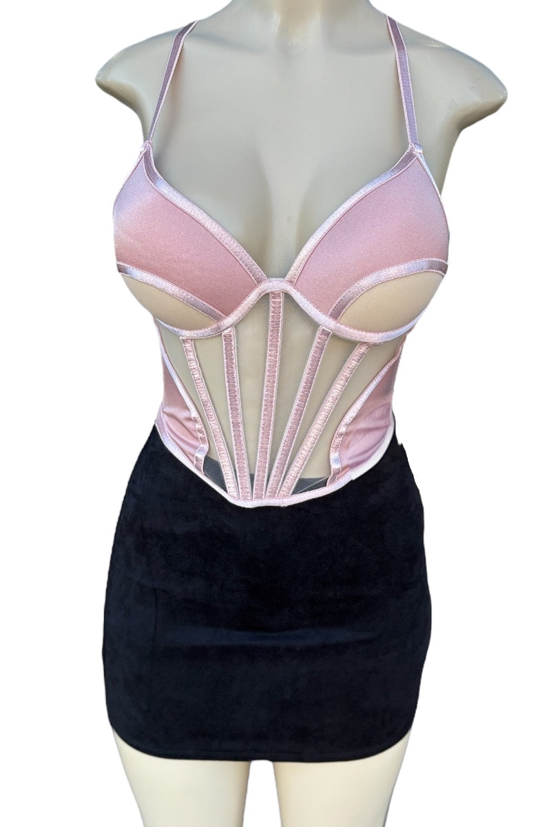 Mannequin wearing a pink corset and black skirt on a white background