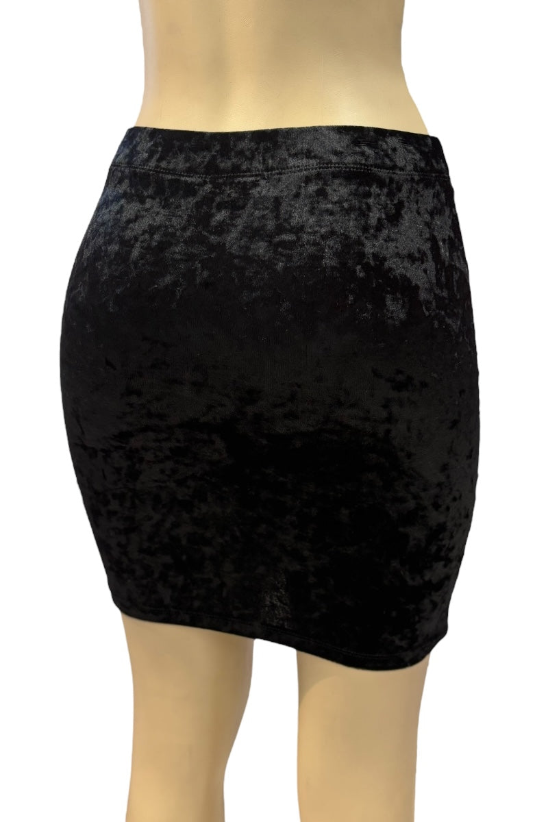 Black velvet skirt on a mannequin against a white background