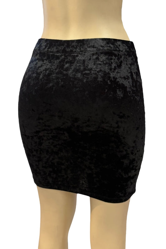 Black velvet skirt on a mannequin against a white background
