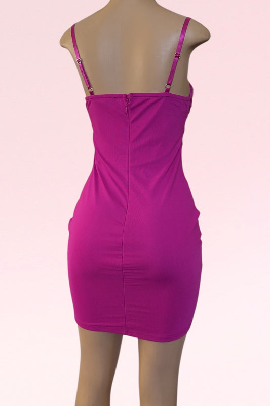 Pink dress on a mannequin against a light pink background