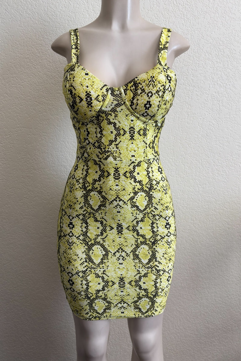 Yellow and black patterned dress on a mannequin against a plain background