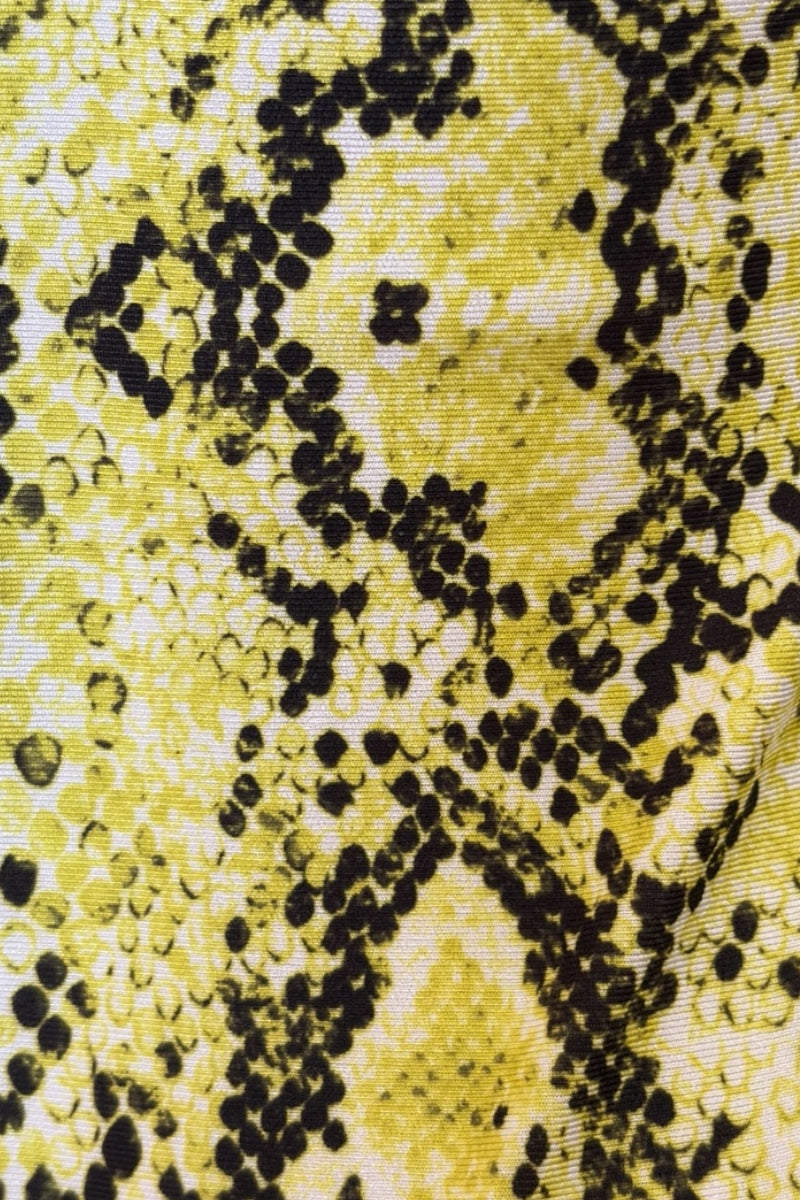 Close-up of a textured fabric with a yellow and black pattern