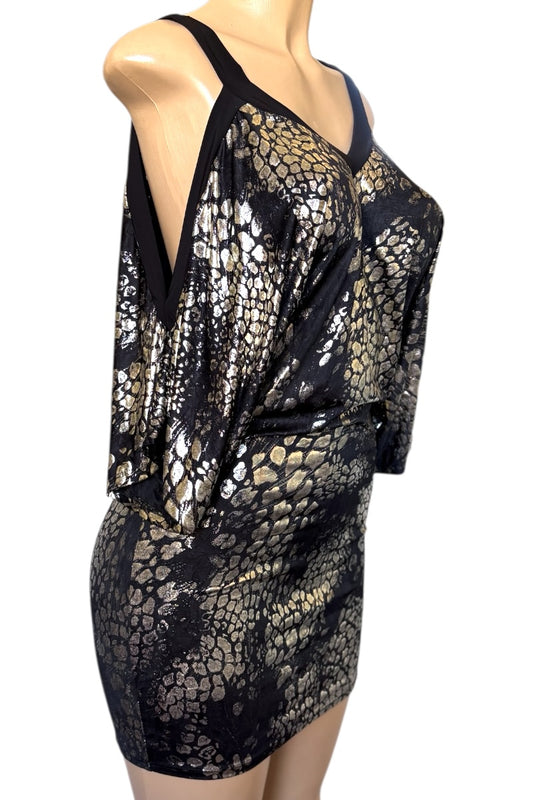 Black and gold patterned dress on a mannequin against a white background