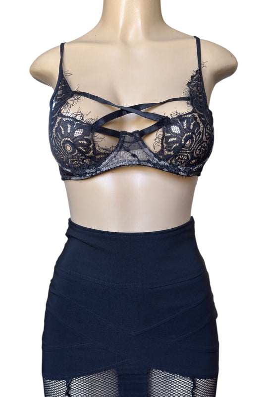 black lace bra and skirt set on a mannequin against a white background