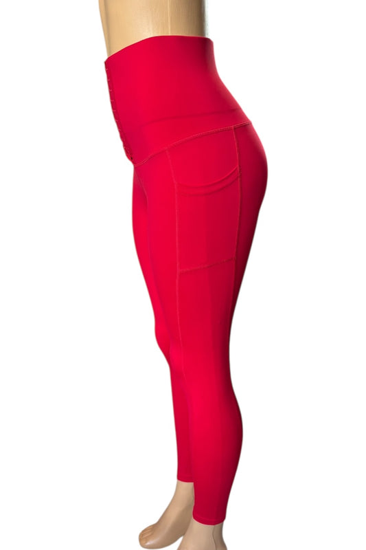 Red leggings on a mannequin against a white background