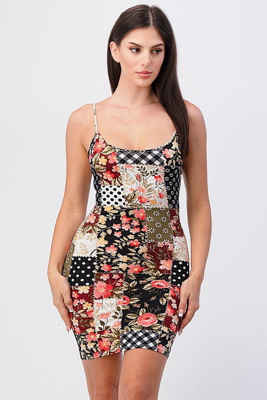Woman wearing a patchwork dress with floral and checkered patterns on a white background