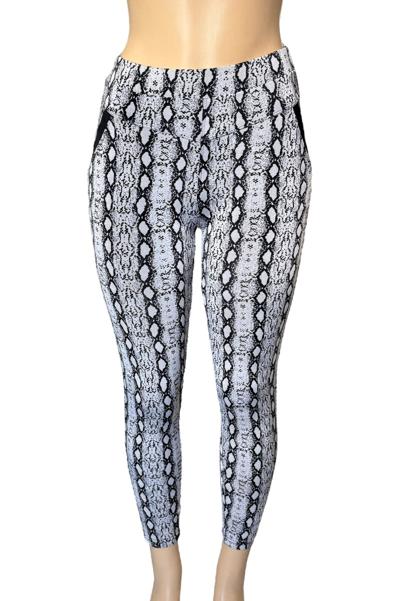 Snakeskin patterned leggings on a mannequin against a white background