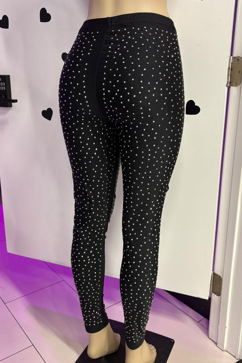 Black leggings with rhinestones on a mannequin against a white background.