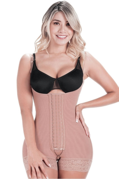 Woman wearing a mocha shapewear garment over a black bra on a white background