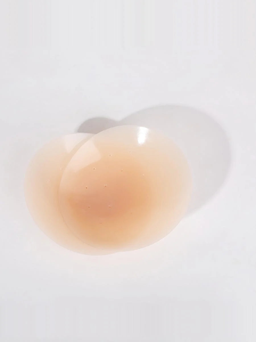Close-up of a beige liquid droplet on a white background