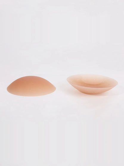 Two silicone nipple covers on a white background