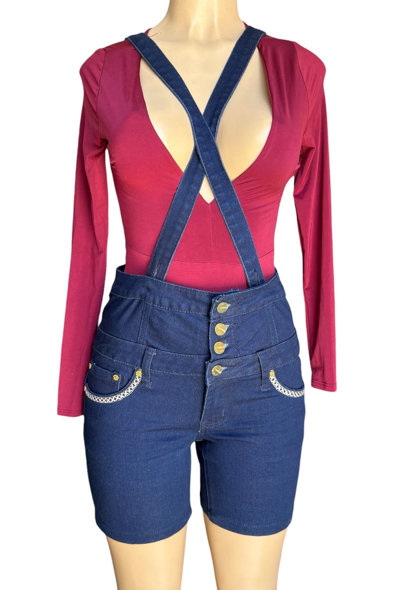 Mannequin wearing a red long-sleeve top and blue denim overalls on a white background