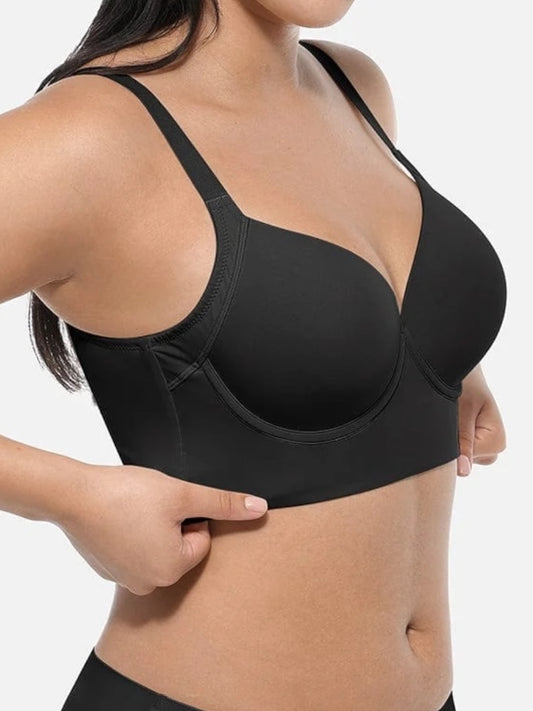 Black bra worn by a person on a plain background