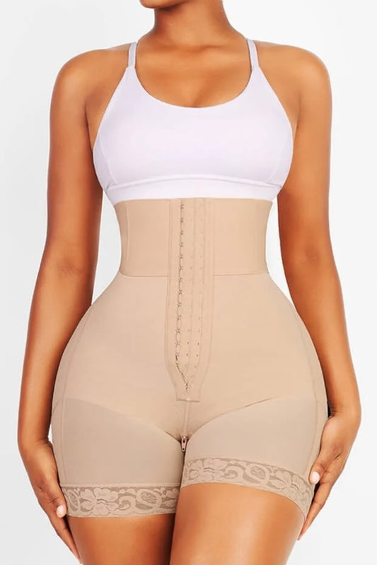 Woman wearing a beige shapewear garment over a white tank top on a light gray background