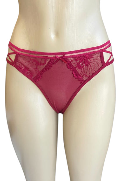 Red lace underwear on a mannequin against a white background