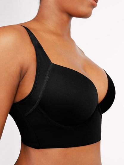 Black bra worn by a person on a plain background