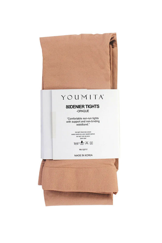 A folded pair of Youmita 80denier tights in a warm beige shade, wrapped with a white paper showing the brand name and product details.