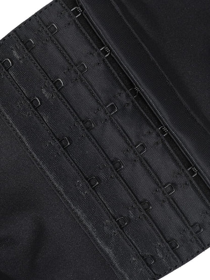 Close-up of a black corset with visible buckles on a white background