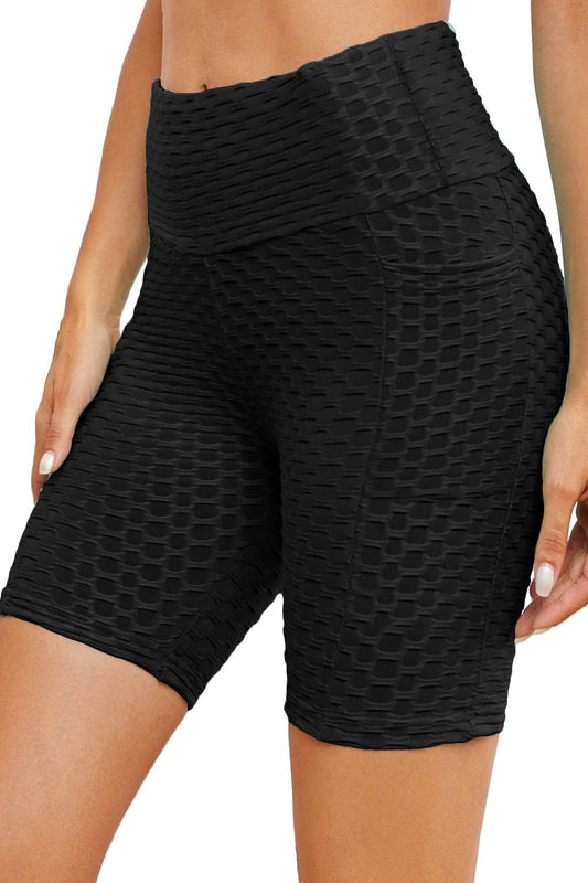 Black textured shorts worn by a person on a white background