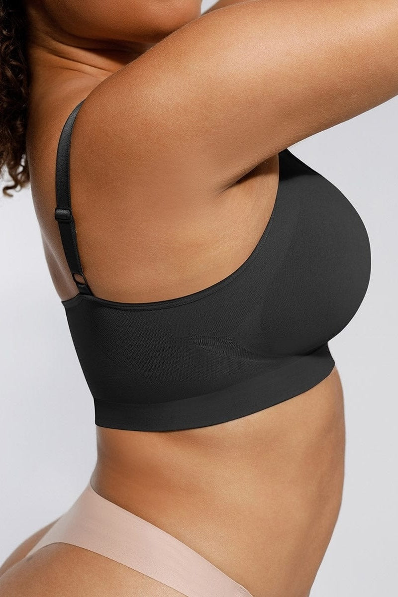 Black bralette top worn by a person on a plain background
