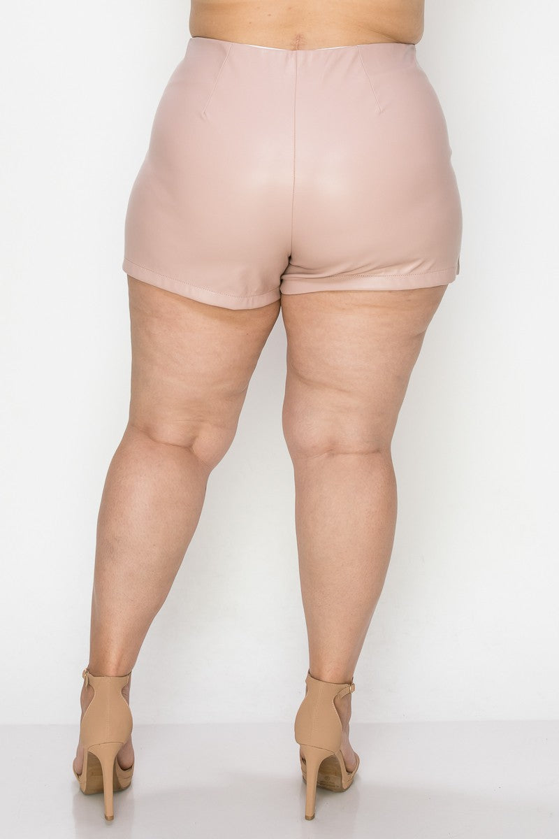Person wearing light pink shorts on a white background