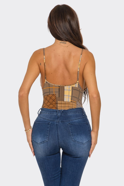 Woman wearing a plaid top and blue jeans on a white background