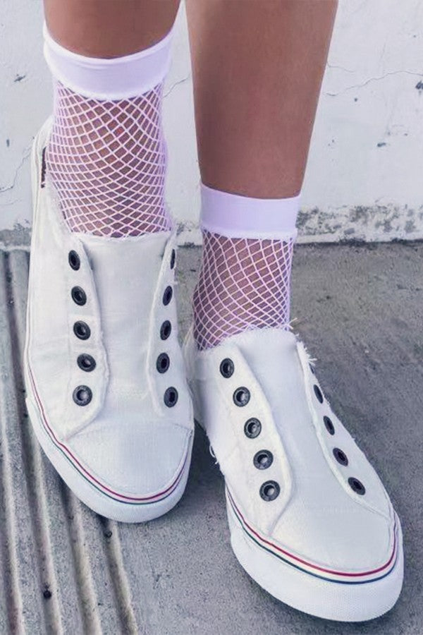 White Small Gauge Fishnet Socks with white shoes on a model's feet on a white background.