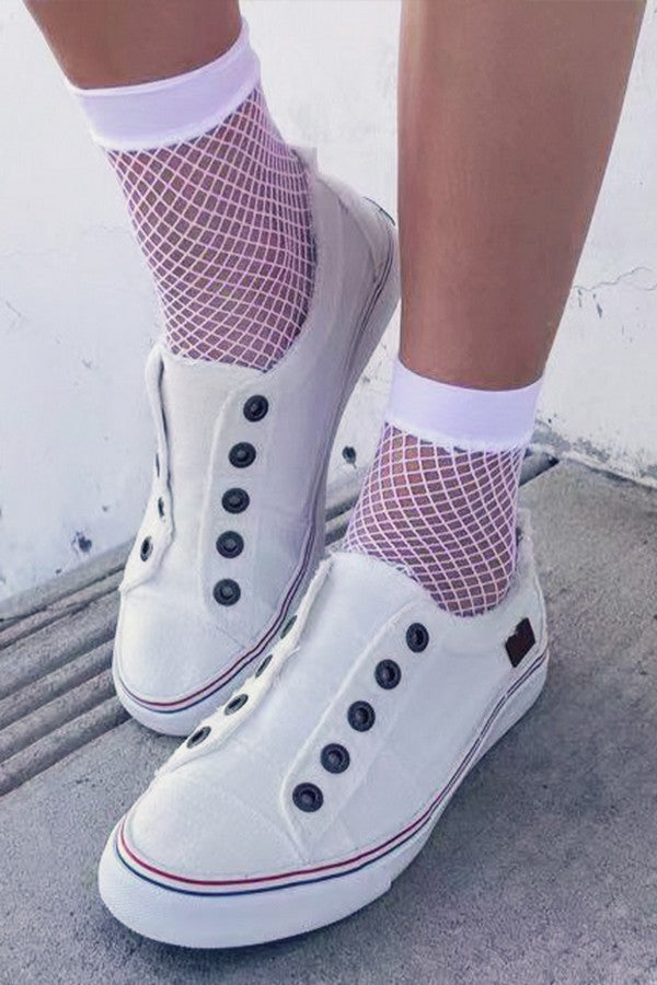 White Small Gauge Fishnet Socks with white shoes on a model's feet on a white background.