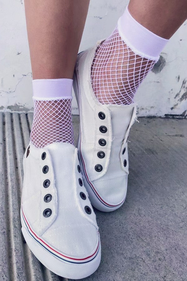 White Small Gauge Fishnet Socks with white shoes on a model's feet on a white background.