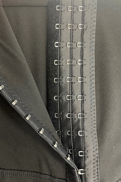 Close-up of leggings with hook and eye closure  details