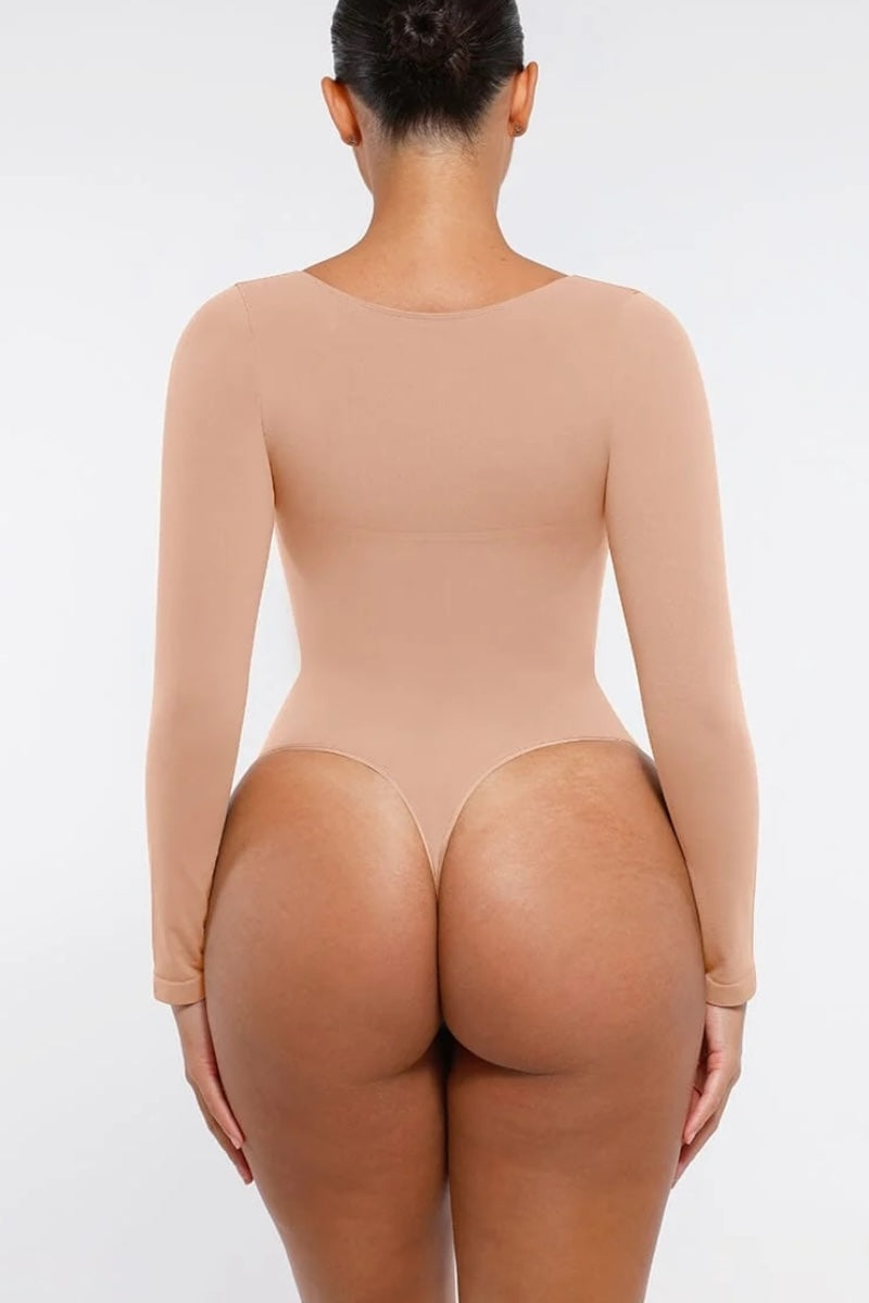 Beige bodysuit worn by a person on a white background