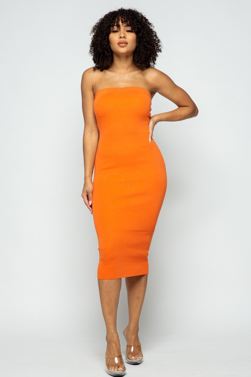 Woman wearing an orange strapless dress on a white background