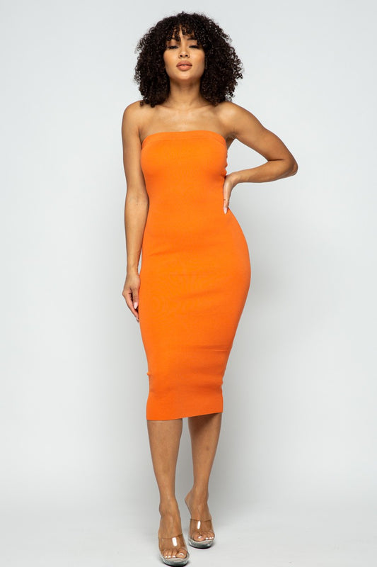 Woman wearing an orange strapless dress on a white background