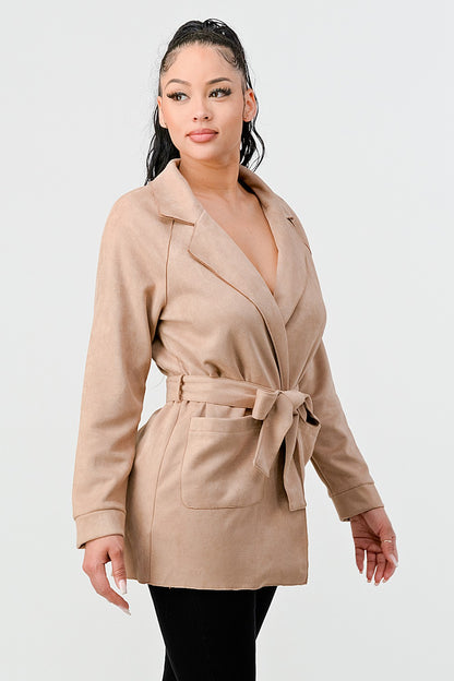 Woman wearing a beige trench coat on a white background