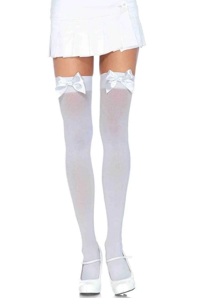 White thigh-high socks with bows and white shoes on a white background