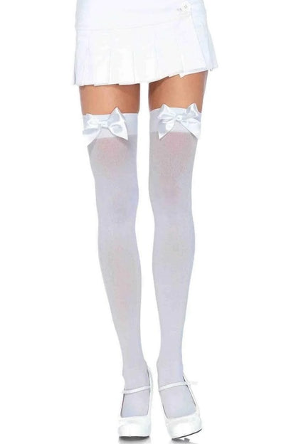 White thigh-high socks with bows and white shoes on a white background