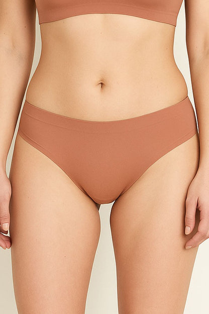 tan bikini bottom worn by a person on a beige background
